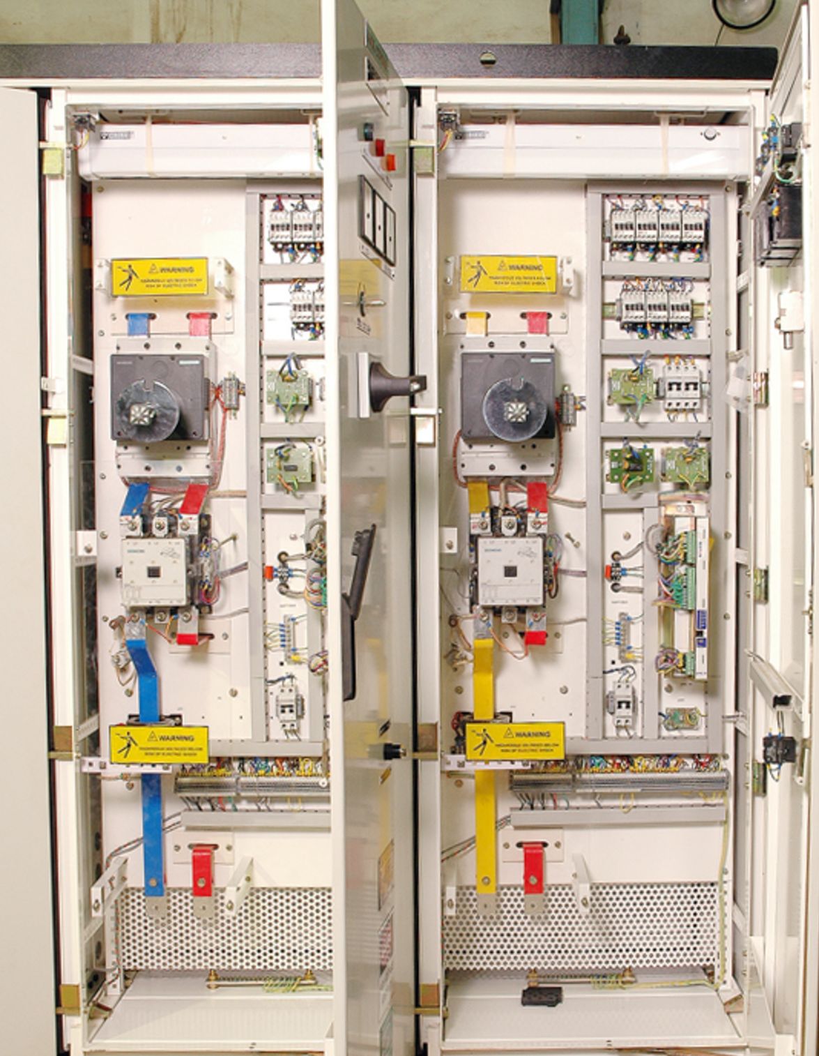 ESP control cabinets with doors open showing contactors, thyristor stacks, control cards and terminal rails