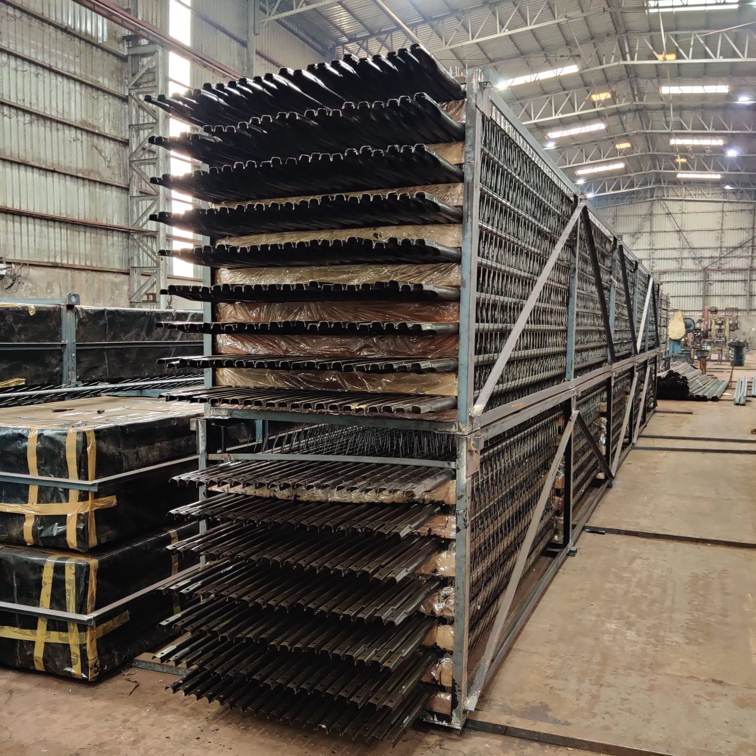 Completed discharge electrode frames racked in the works with barbed emitting elements visible
