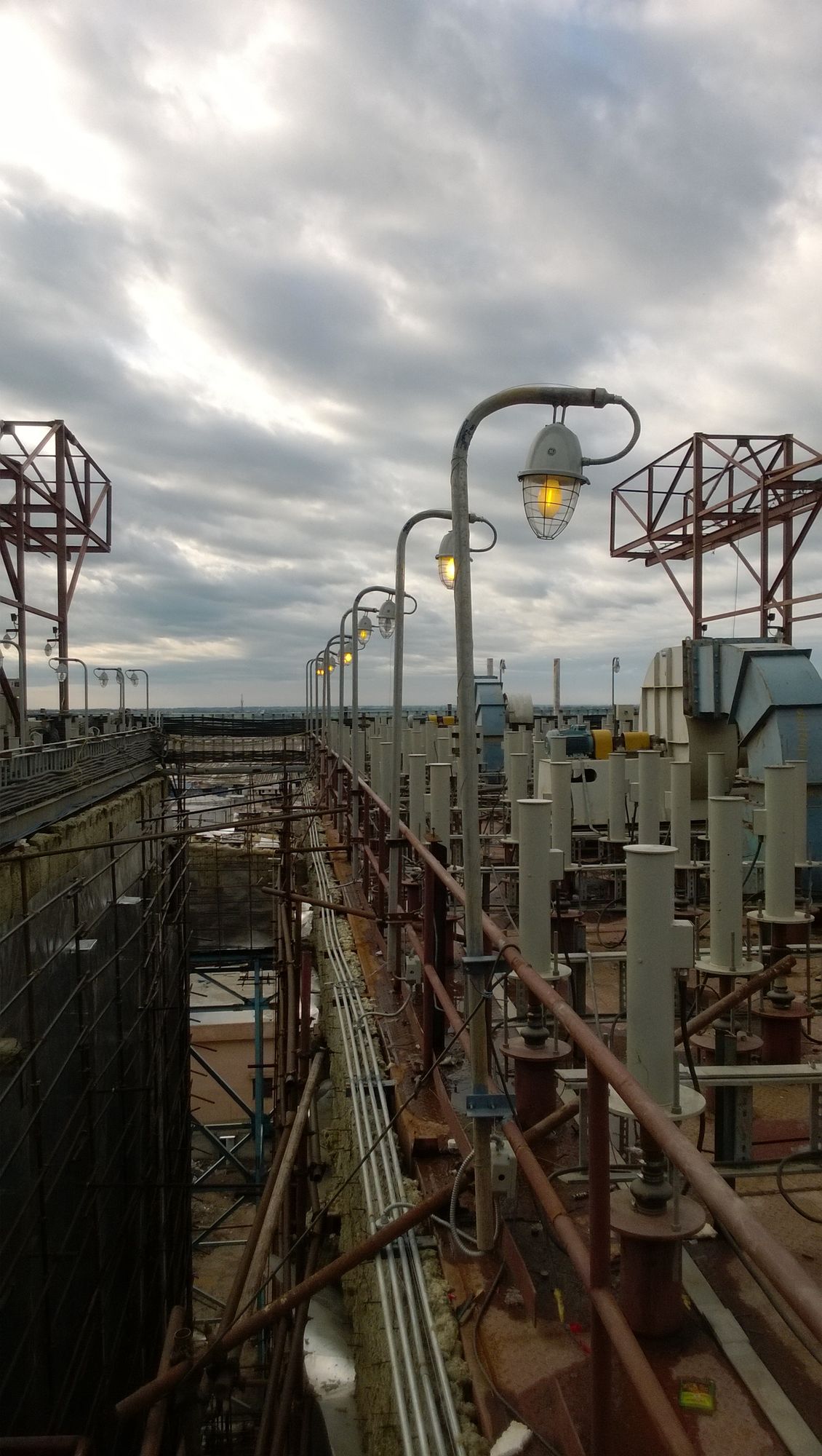 Electrostatic precipitator roof with insulator housings and rapping drives at dusk