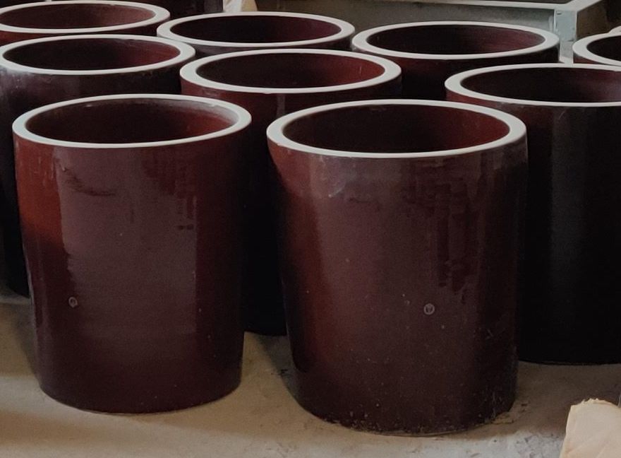 Glazed cylindrical hollow ceramic support insulators for ESP discharge electrode suspension