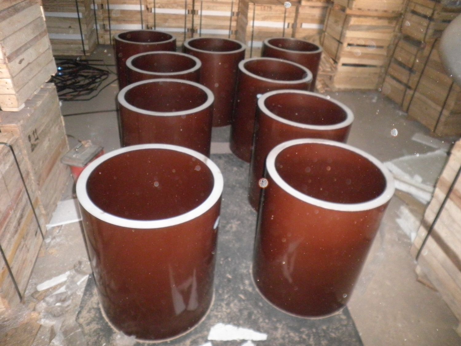 Glazed hollow ceramic support insulators with white-glazed rims, crated at the works