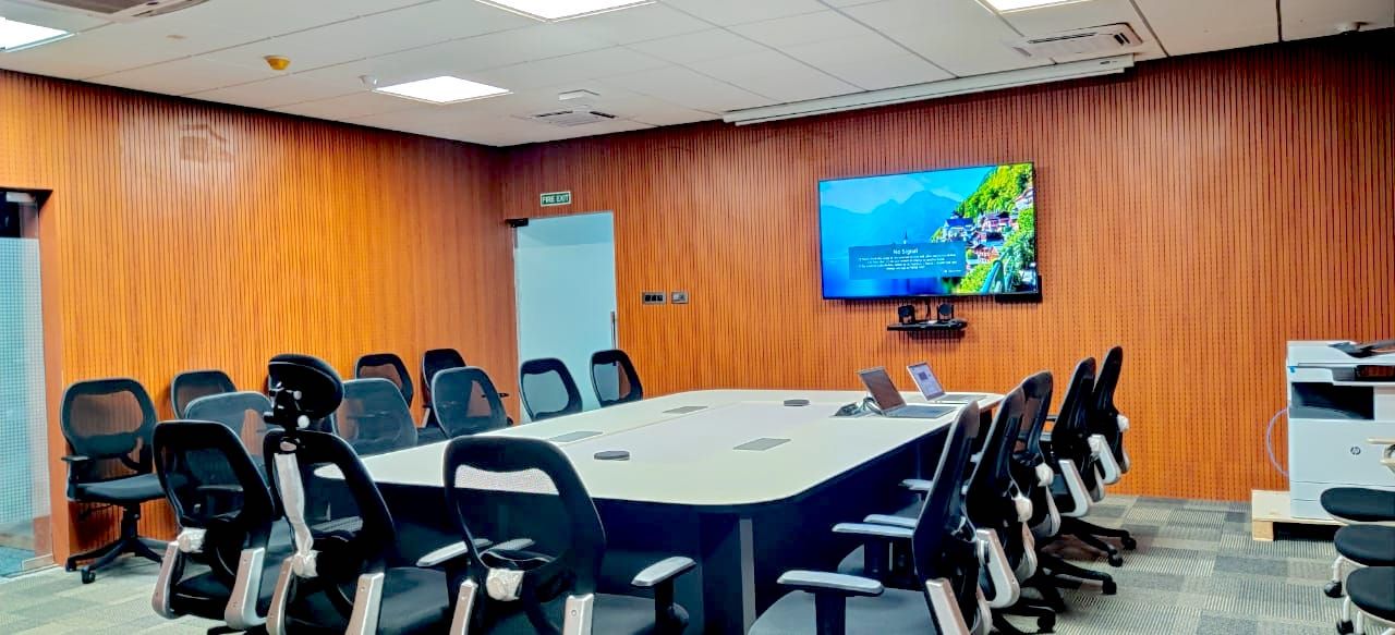 Conference room with a large format display and video conferencing equipment integrated into the table
