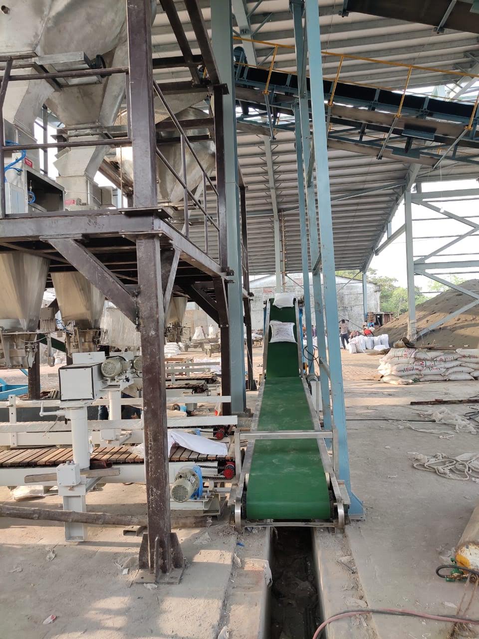 Complete automatic bagging line with weigh hoppers, bagging machines and finished bag conveyors in a bulk handling plant