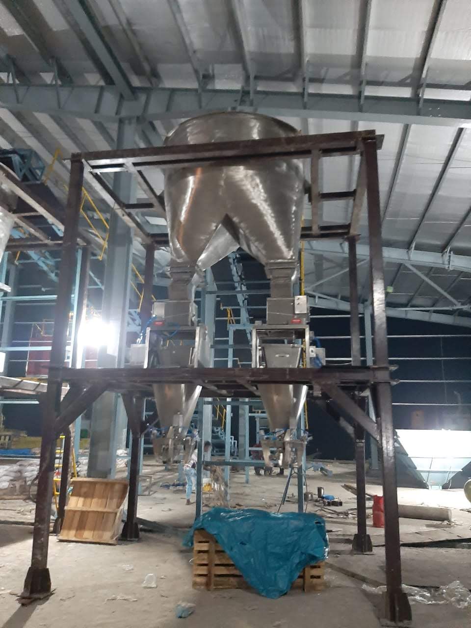 Twin weigh hoppers on a steel structure feeding the bagging machines below