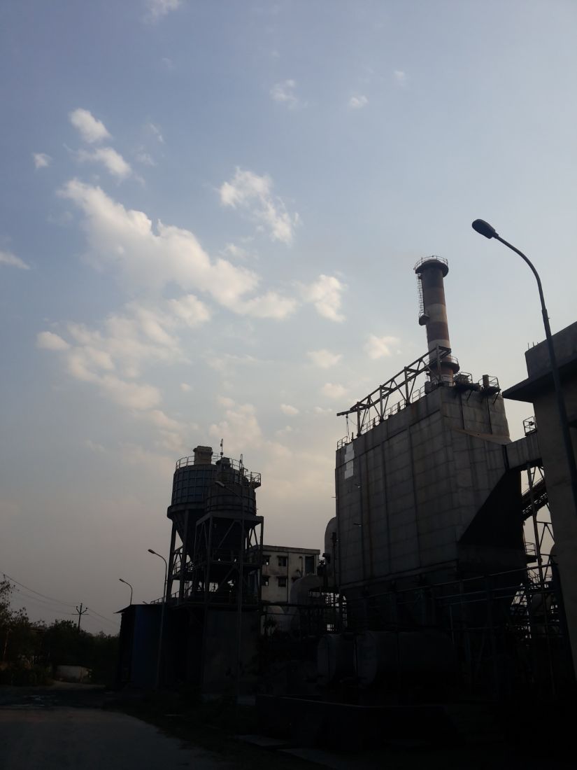 Process plant with electrostatic precipitator and stack at dusk