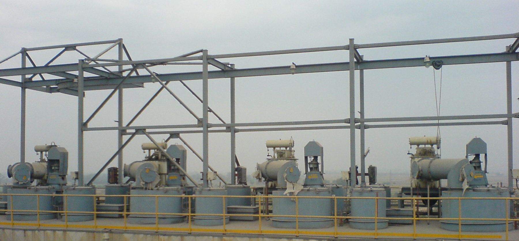 Row of transformer rectifier sets with their high-voltage insulator housings along an ESP roof
