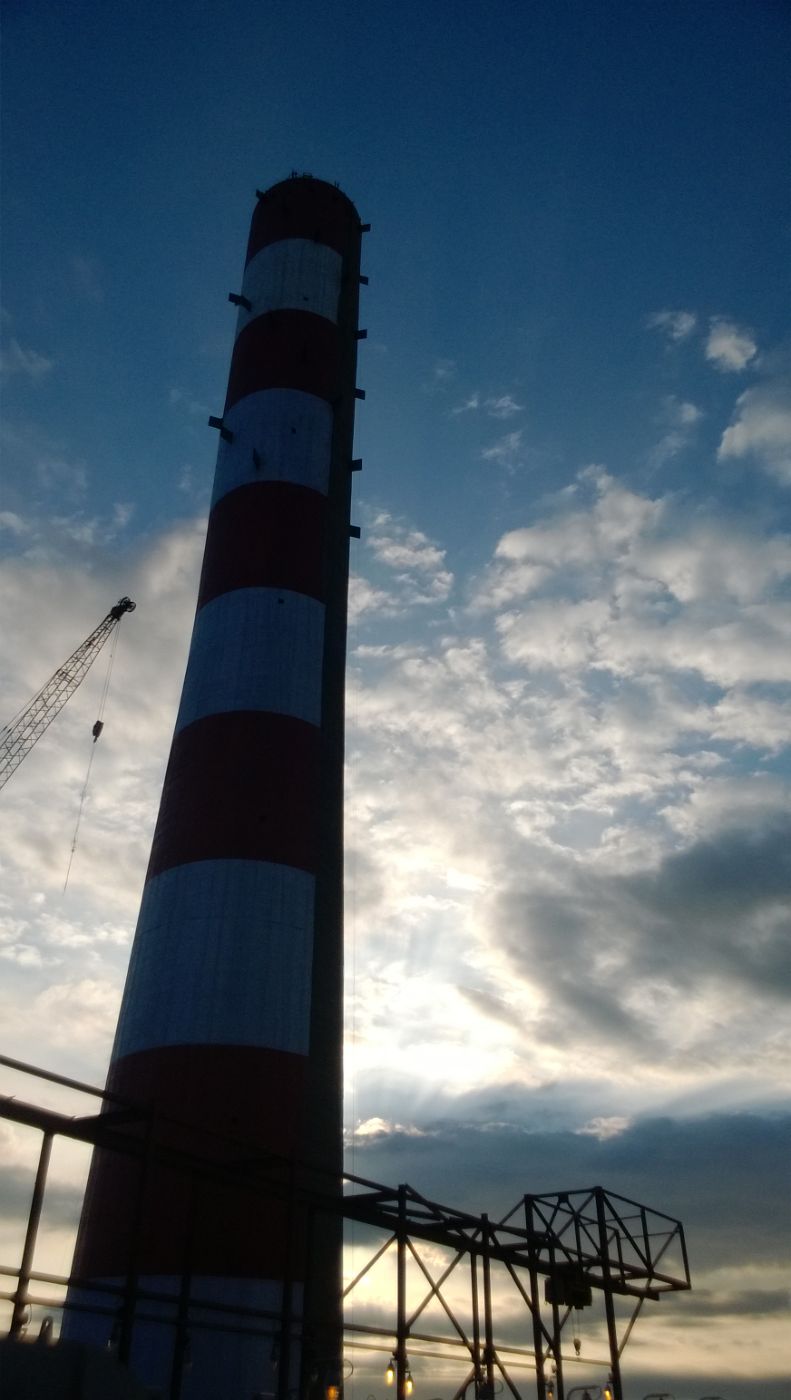 Industrial stack against sky at a plant served by Aeon Tech Solutions